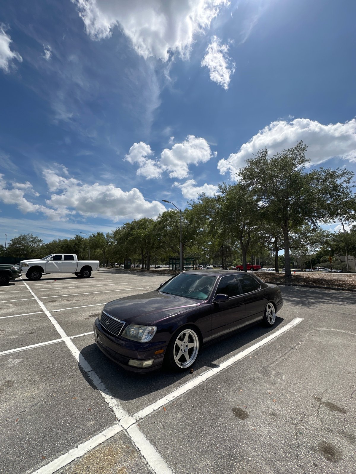 Purple sedan with custom wheels parked diagonally in Tampa lot
