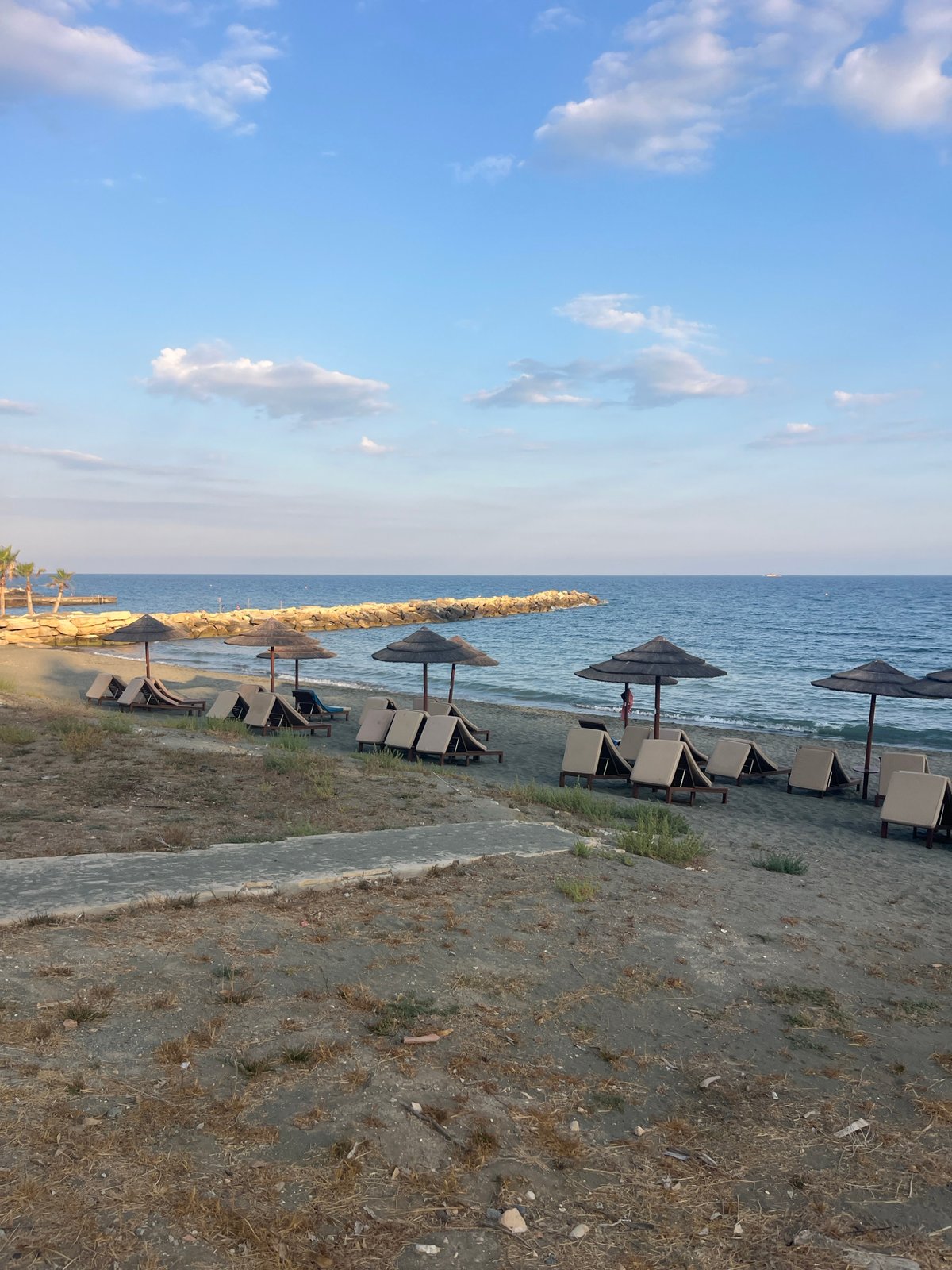 Cyprus coastal promenade with beach, gardens, and offshore water park