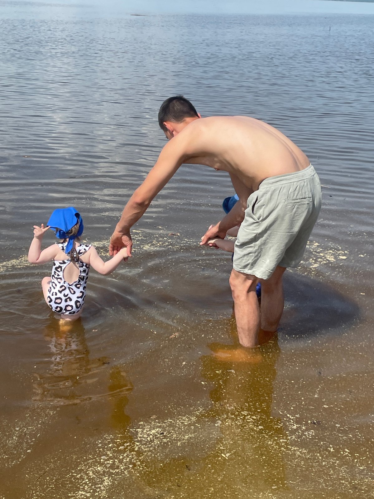 Families enjoy morning beach time along Kama River in Perm