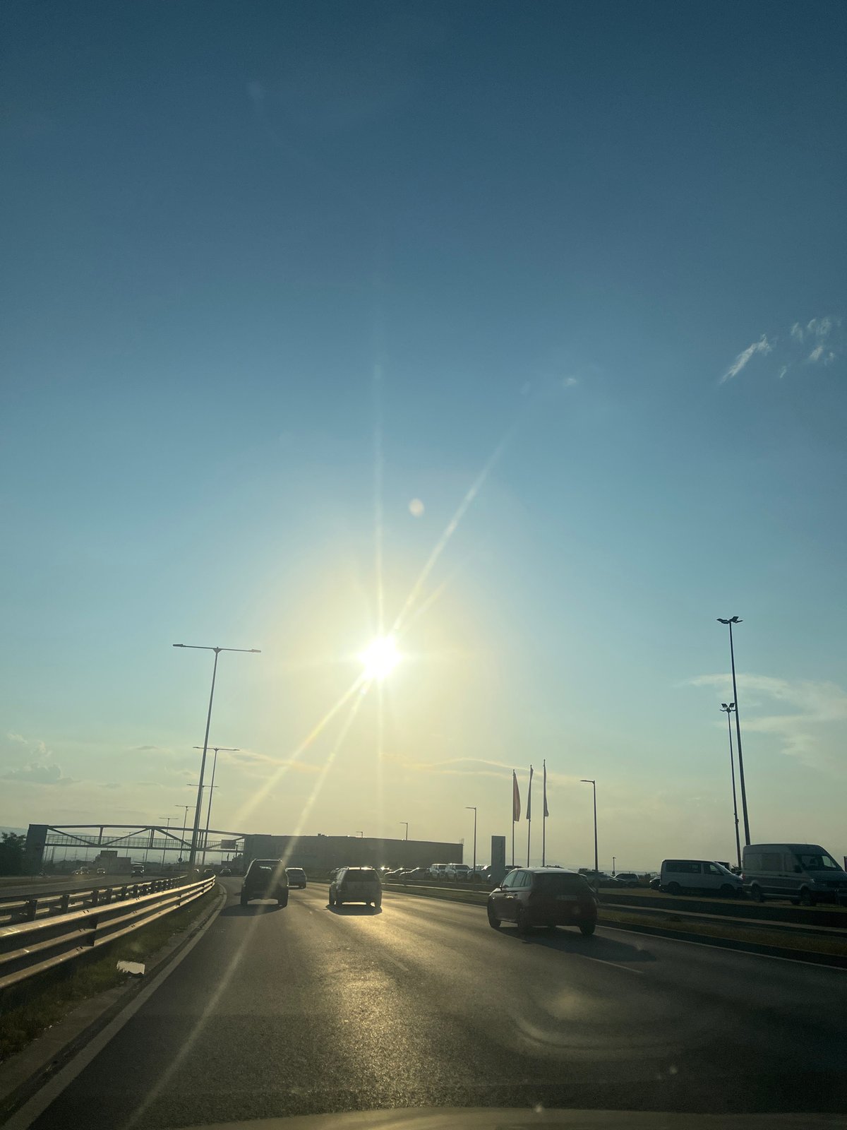 Rolling highway footage, sun out, mixed traffic moving along