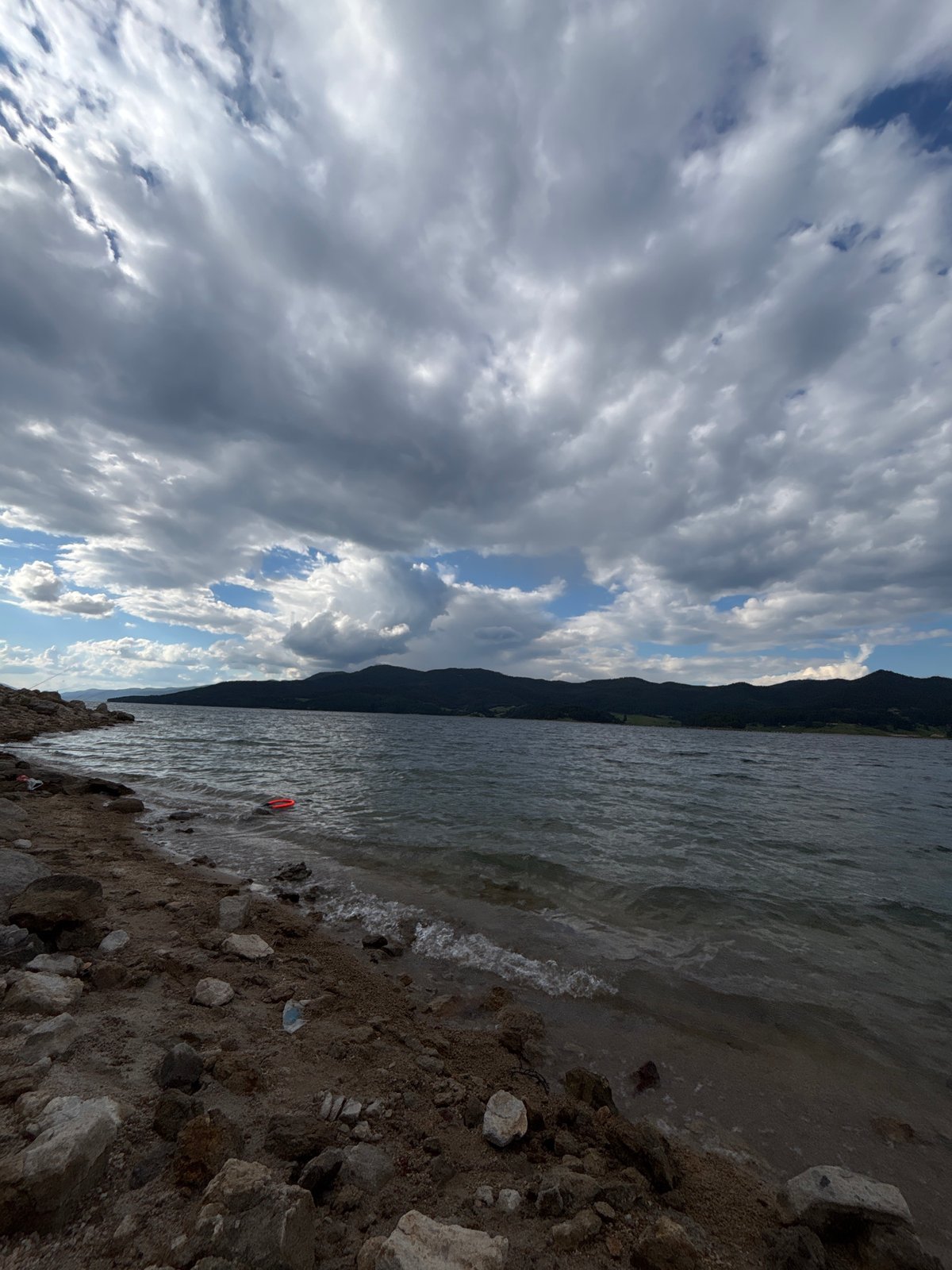 Rocky lakeshore with mountain backdrop, shot from several angles