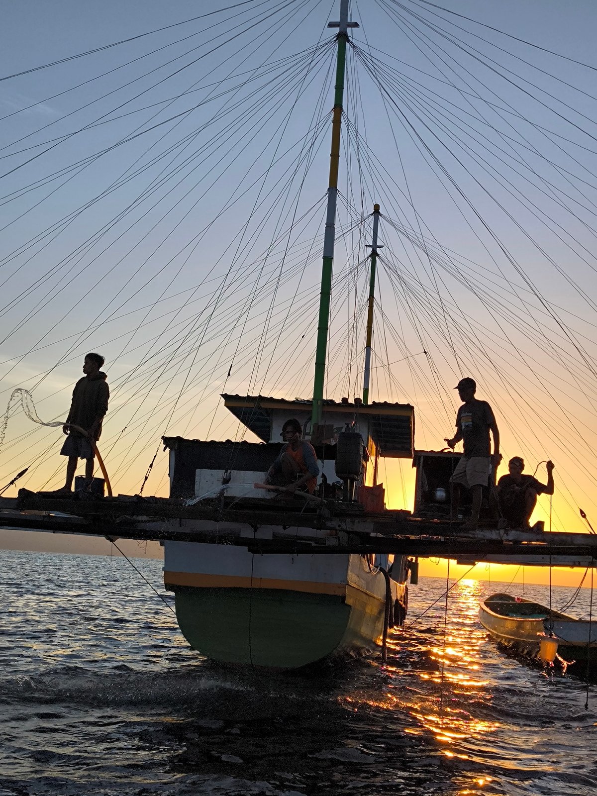 Fishing boat expedition documented in Indonesian waters at sunset