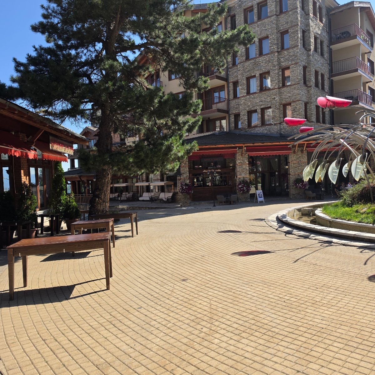 Sunny morning at Razlog resort area with fountain sculpture
