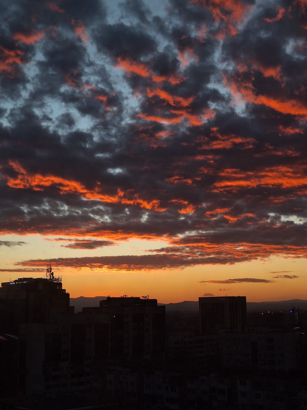 Dramatic sunset lights up cloudy sky over Sofia