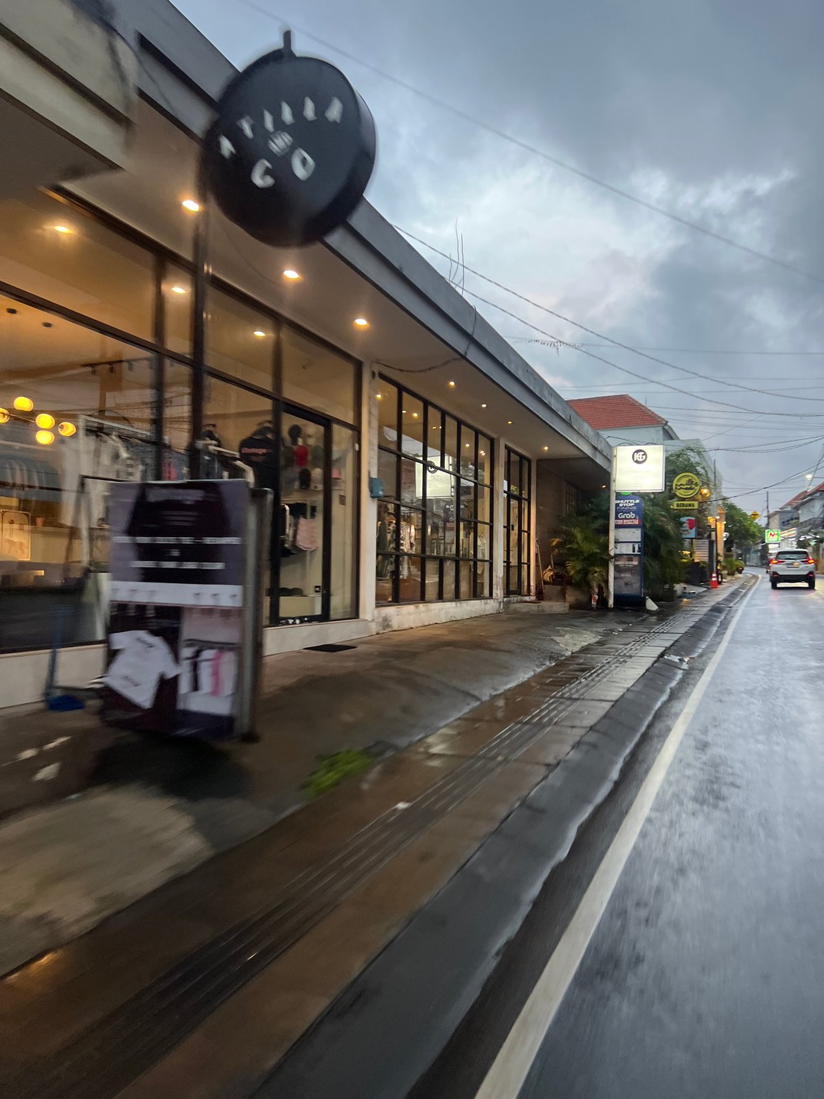 Evening scooter commuters navigate wet streets in North Kuta
