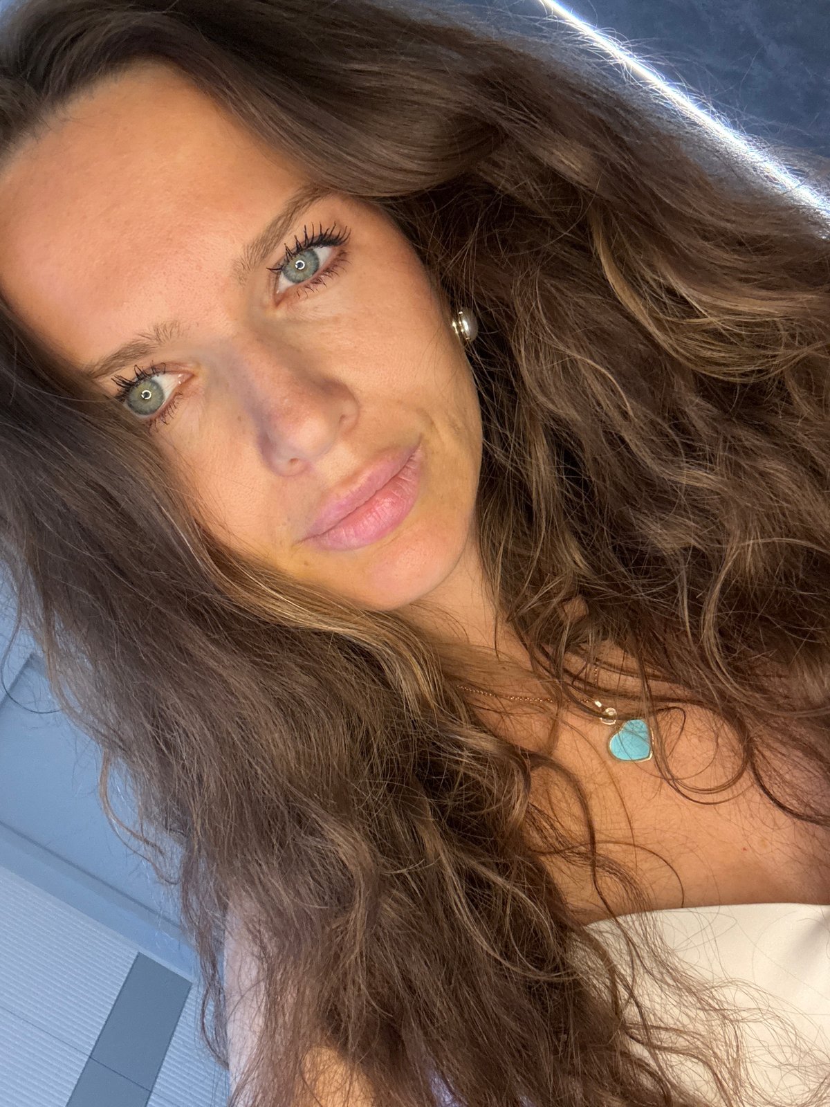 Quick selfie series in a Moscow interior, white top and turquoise pendant