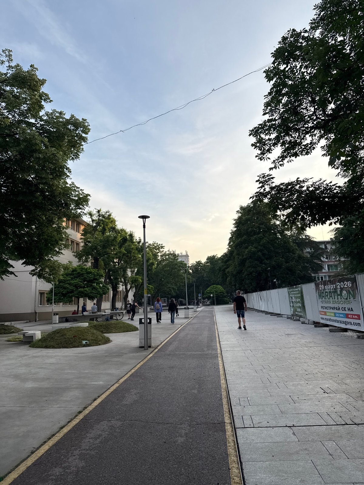 Evening stroll with small dog captured on Stara Zagora promenade