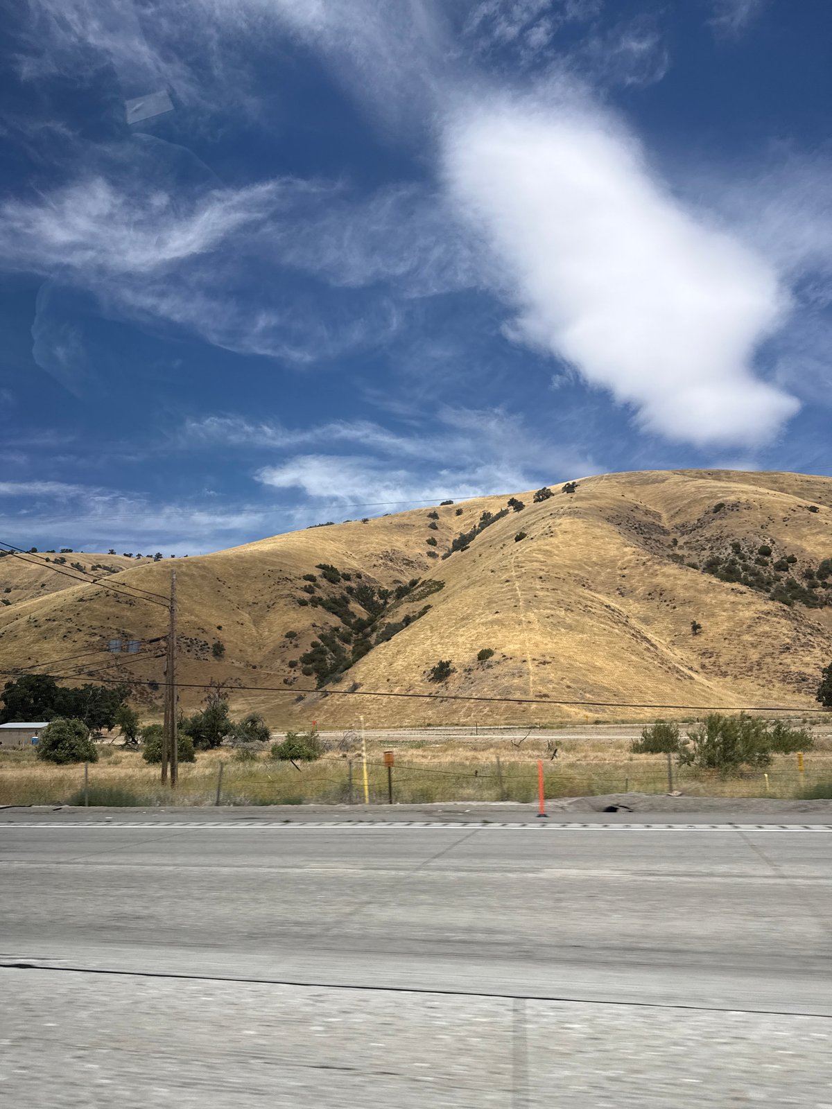 Highway drive through dry golden hills near Lebec, California