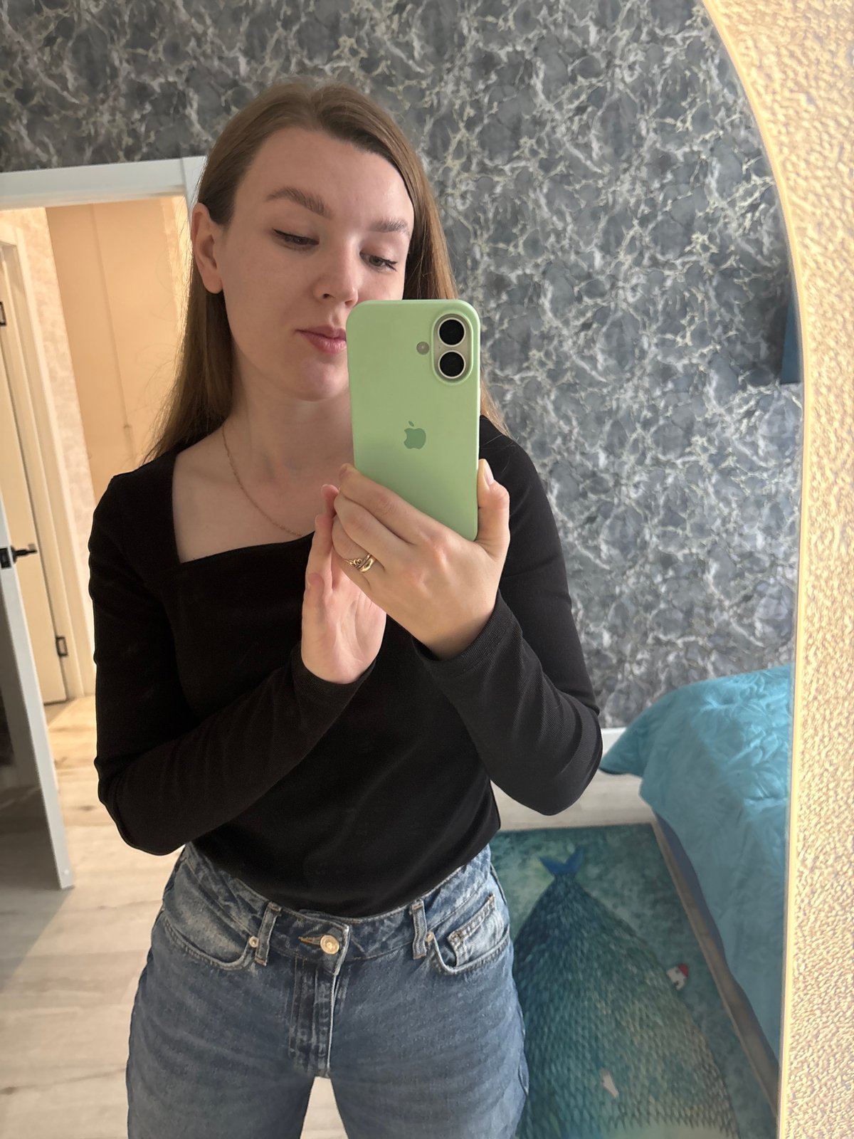 Woman takes mirror selfie with cats watching in Izhevsk