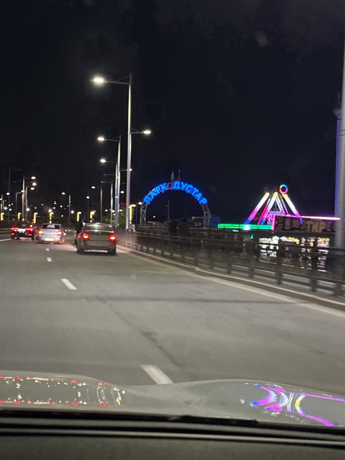 Nighttime traffic documented on illuminated Ufa roadway