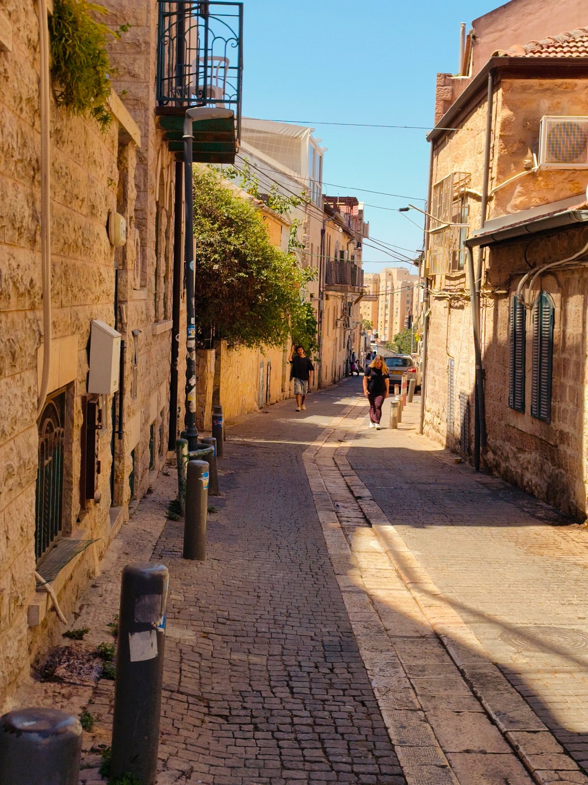 Morning light on a quiet cobblestone alley in Jerusalem