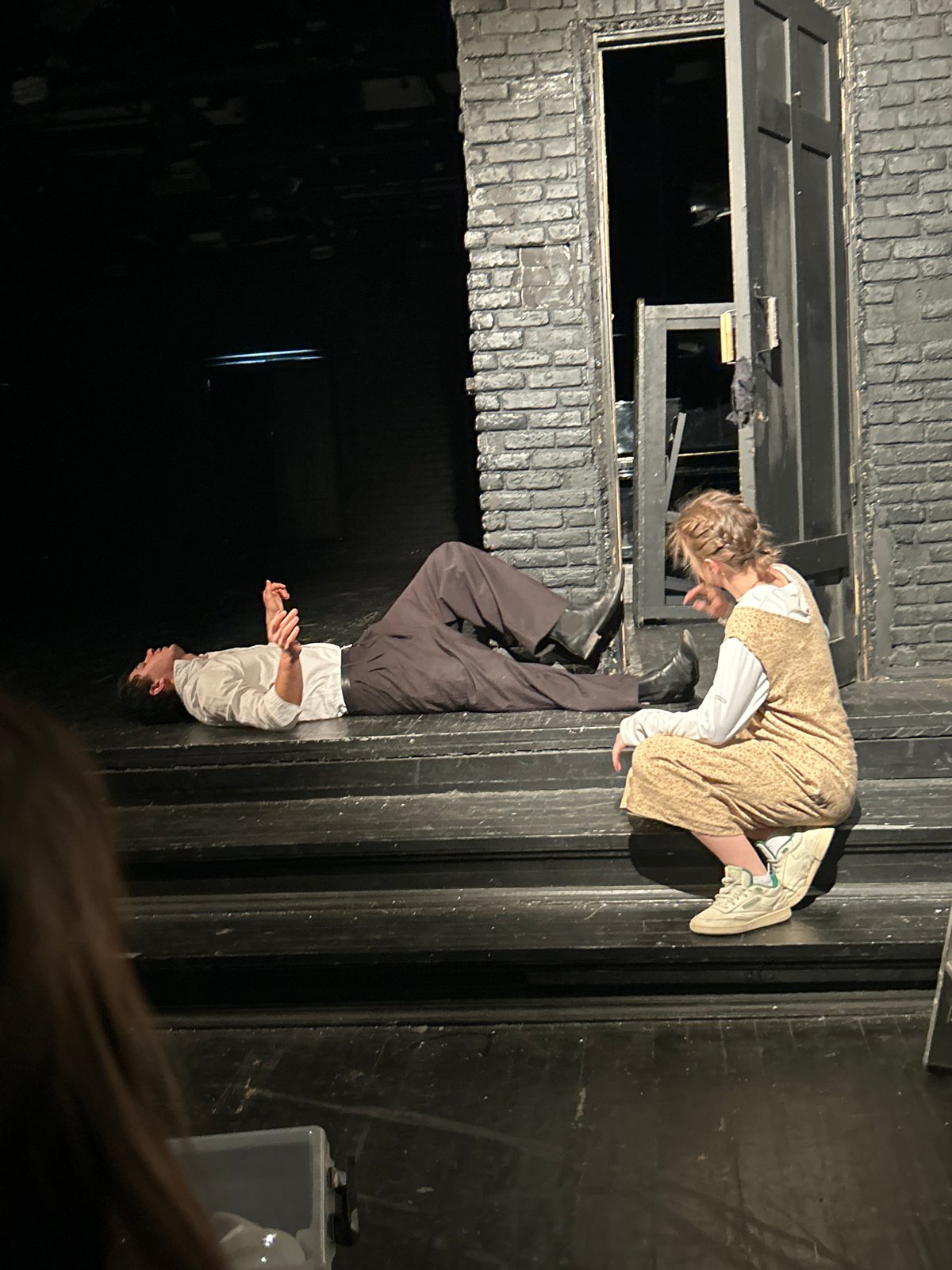 Theatrical performance captured by witnesses on stage with period costumes