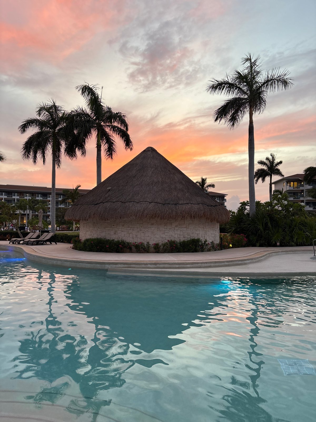 Sunset poolside at a Punta Sam resort, Delphinus Maroma