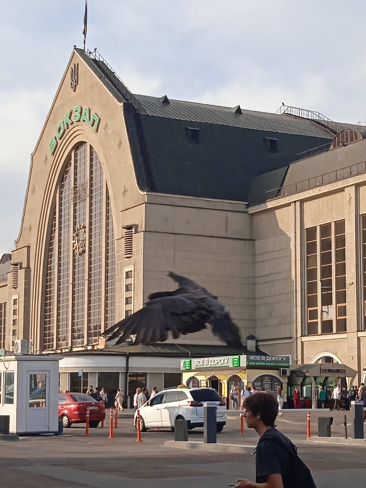 Pink clock tower and train station with Cyrillic signage