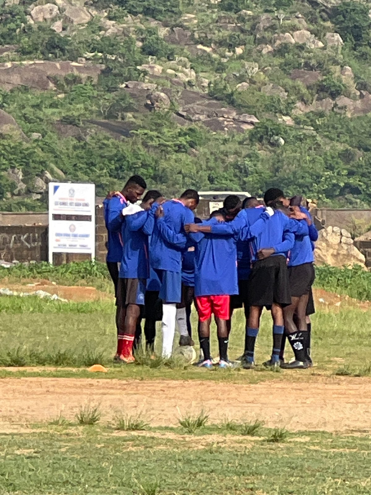 Two soccer teams train on a Jos field at dawn