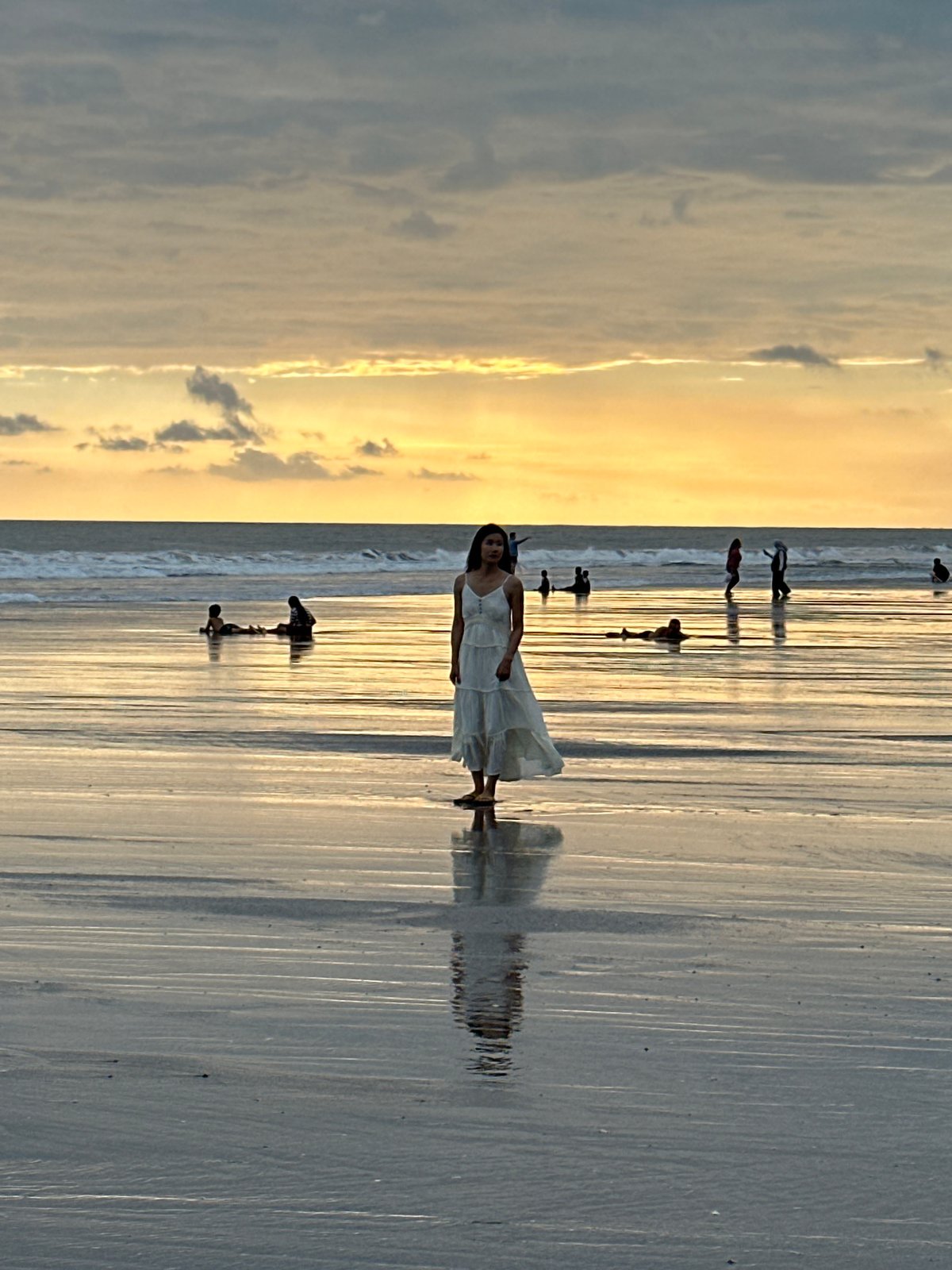 Busy North Kuta beach sunset with families and a photo shoot