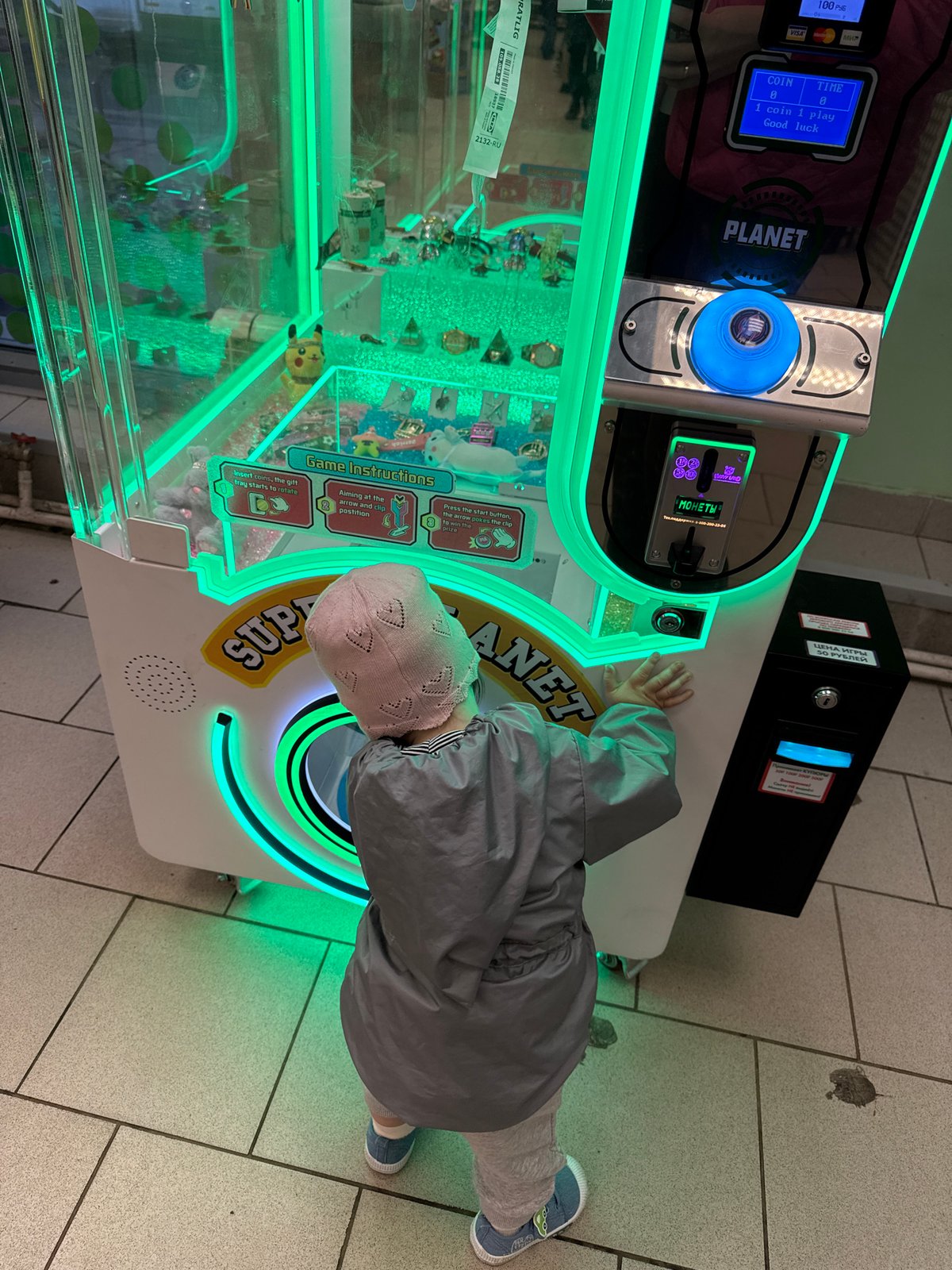 Child plays arcade games amid spring blossoms in Moscow