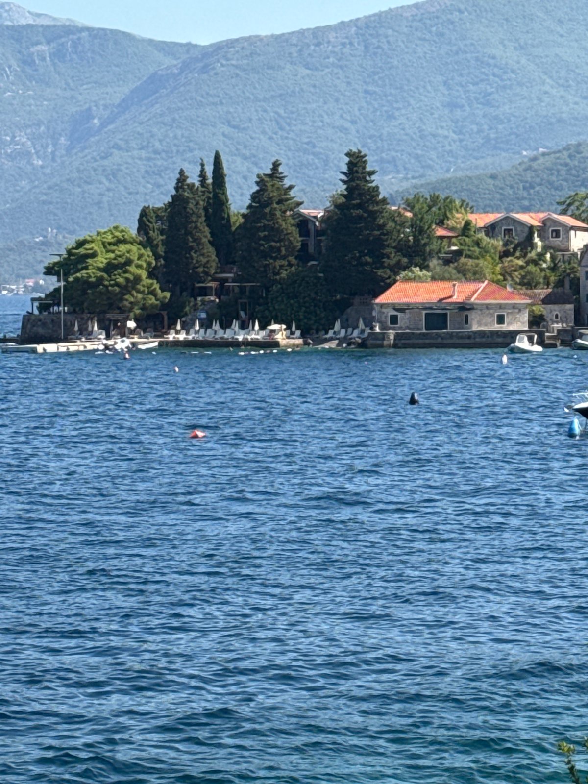 Morning at a Mediterranean waterfront with boats and selfies