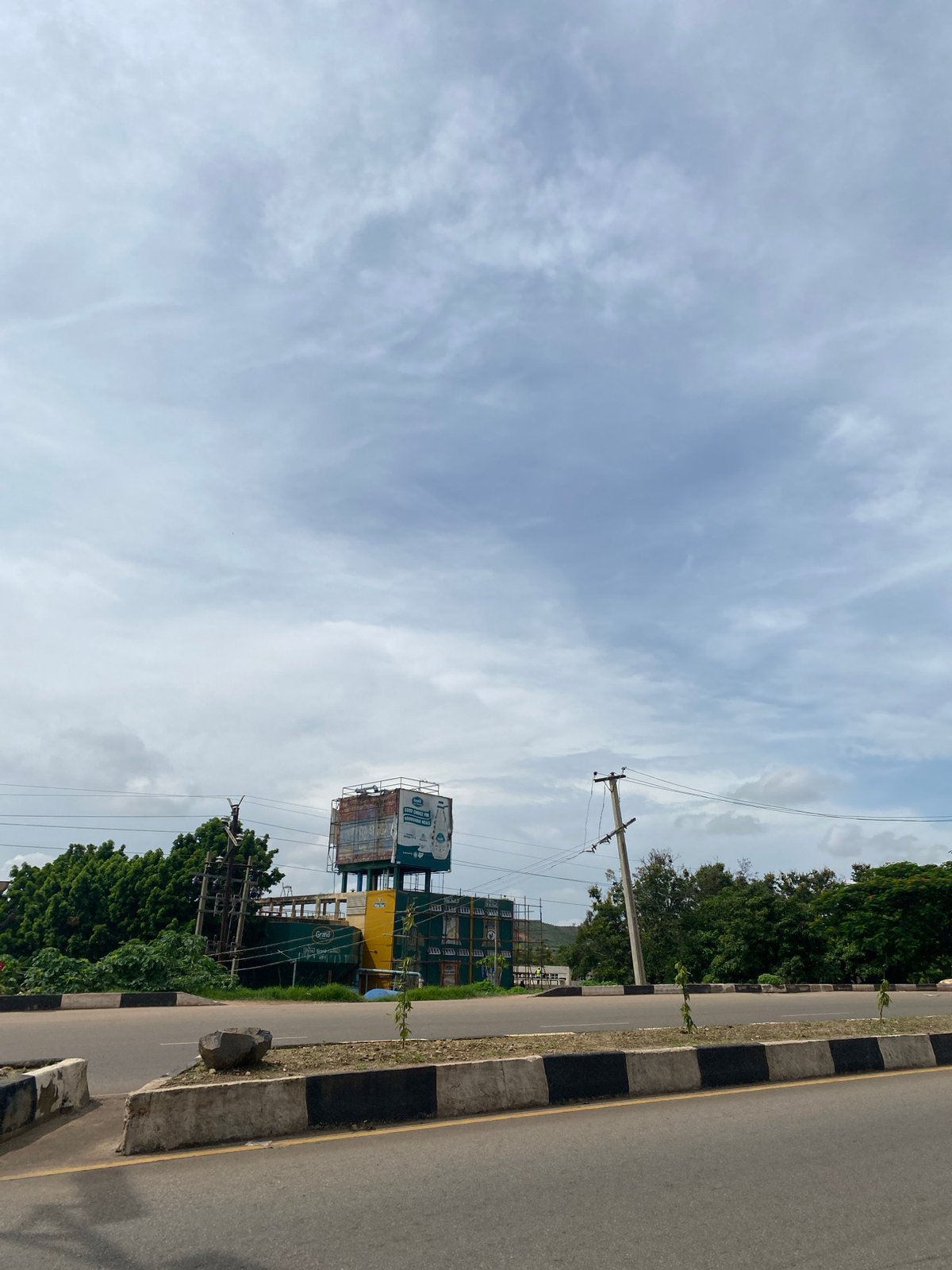 Morning traffic and street scenes along a Jos city road