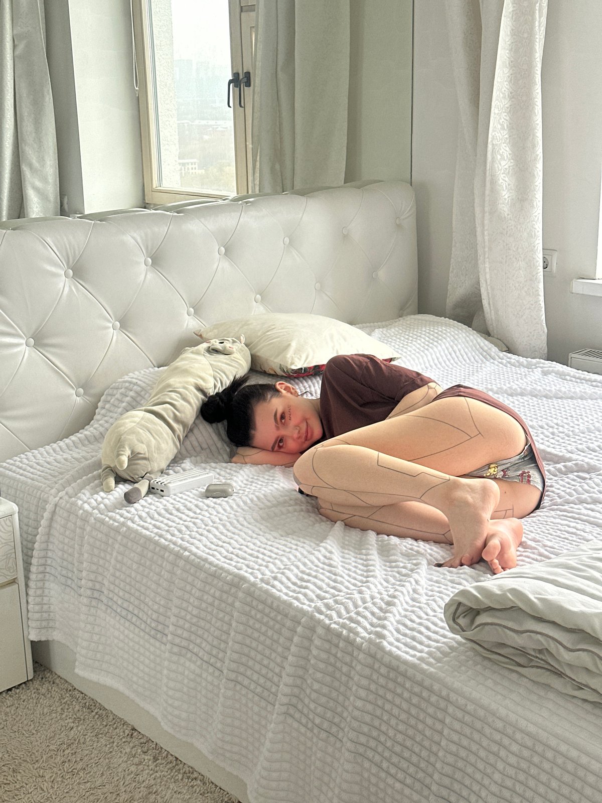 Person observed resting on bed in Moscow apartment