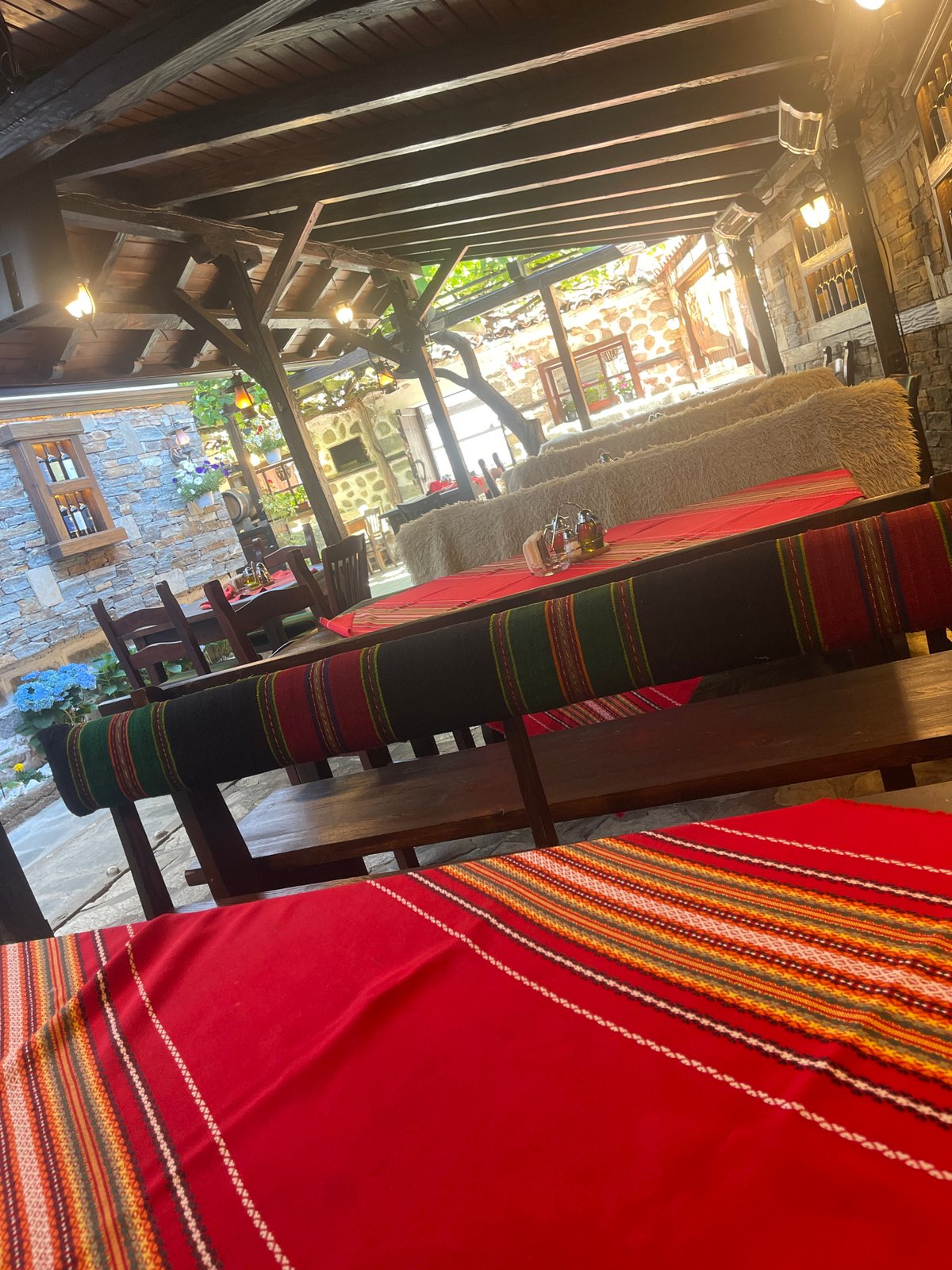 Outdoor dining setup with decorated tables and flower arrangements