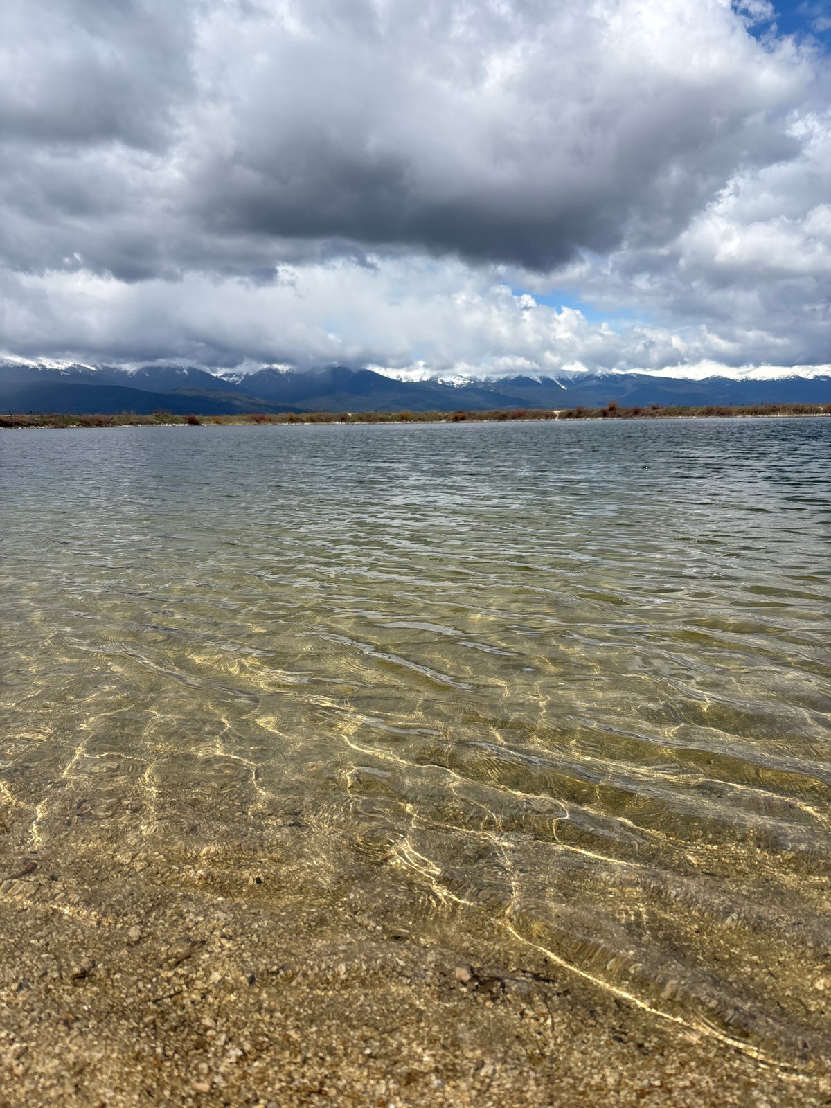 Person enjoys lakeside relaxation near Bansko mountain lake