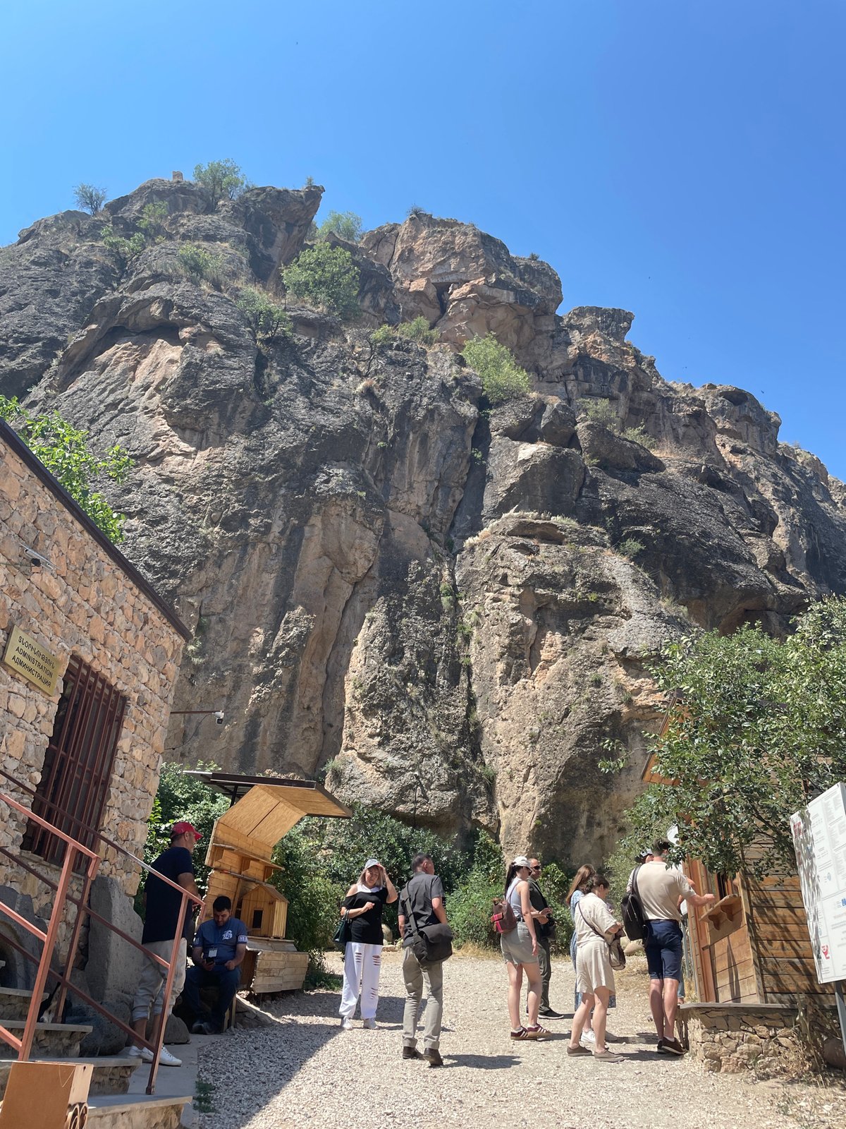 Tourists pause at Areni's cliff-base administration building