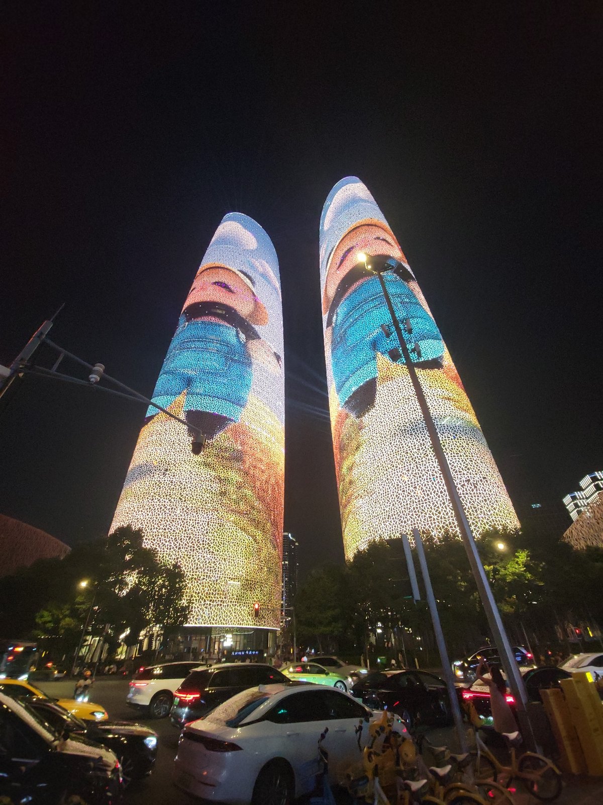Chengdu's twin towers cycling through vivid LED facade displays at night