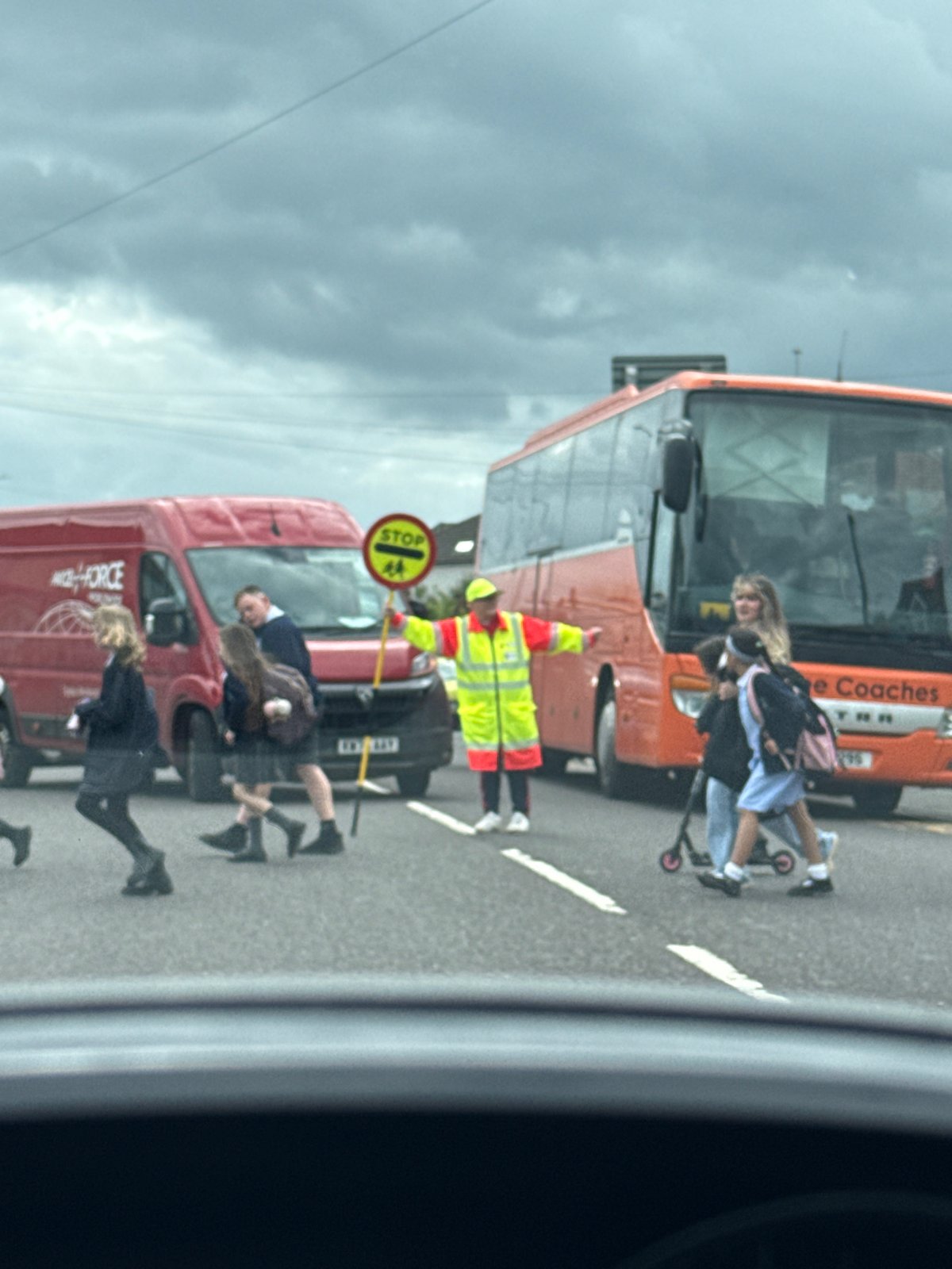 School crossing guard helps children cross street in Great Yarmouth