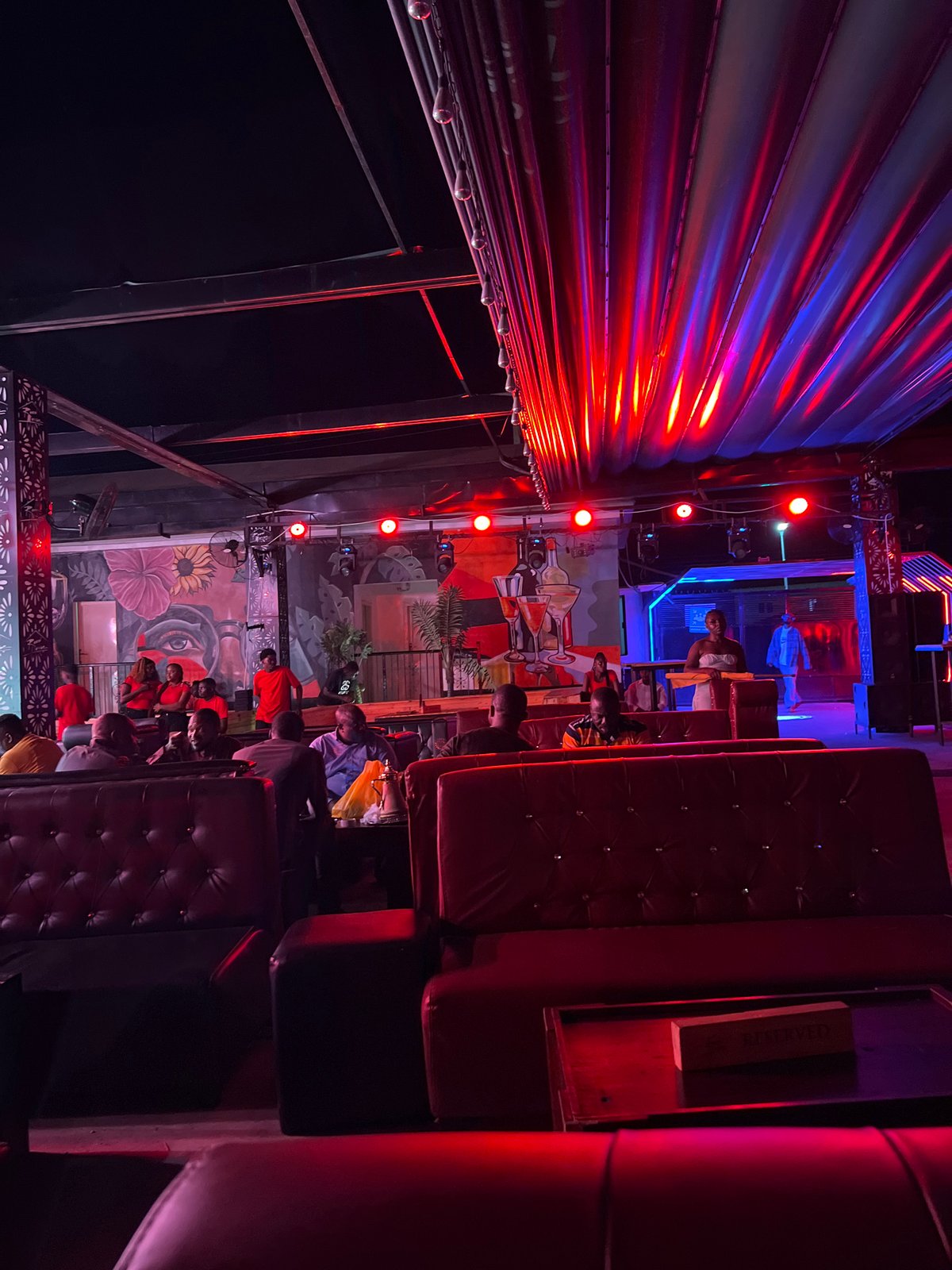 Night venue in Howayi lit up with DJ setup and lounge areas
