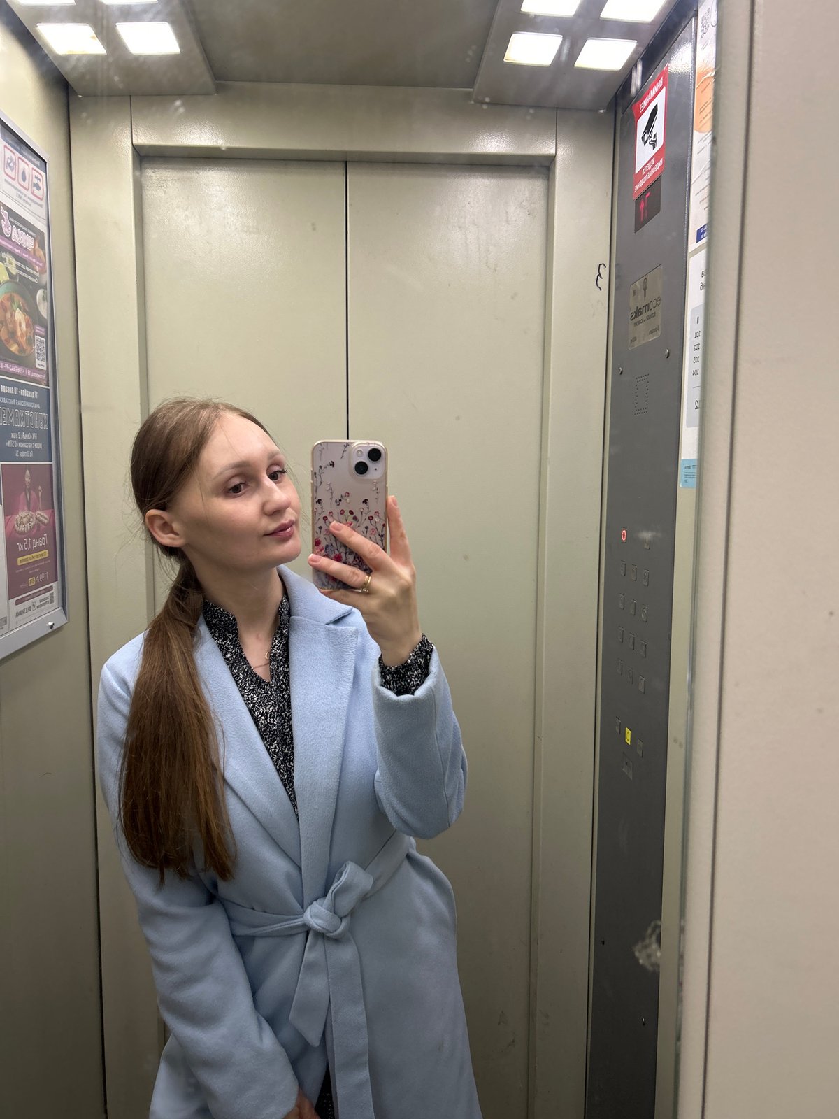 Woman takes selfie in Ufa elevator