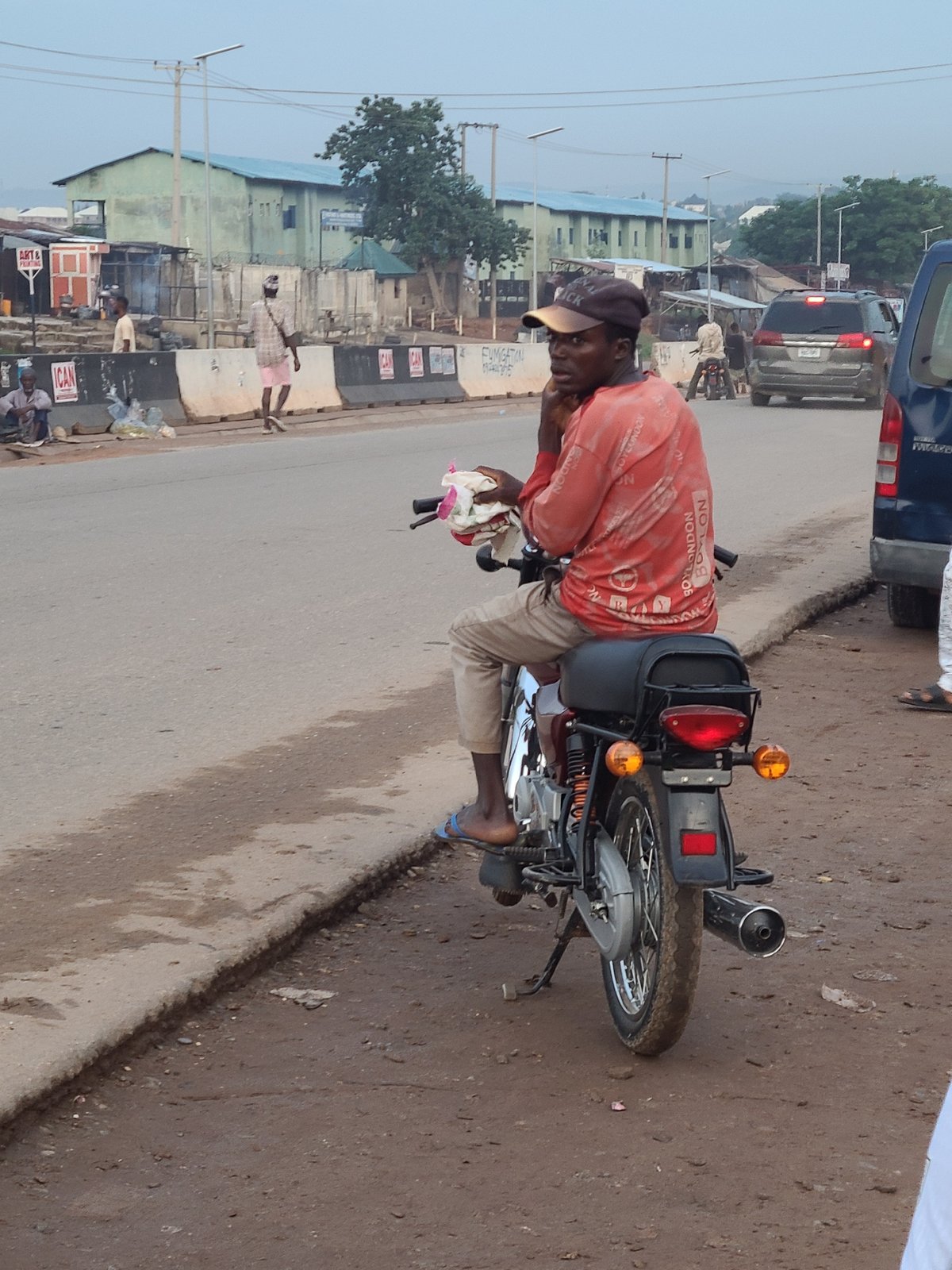 Everyday street activity along a roadside in Ado, Nigeria