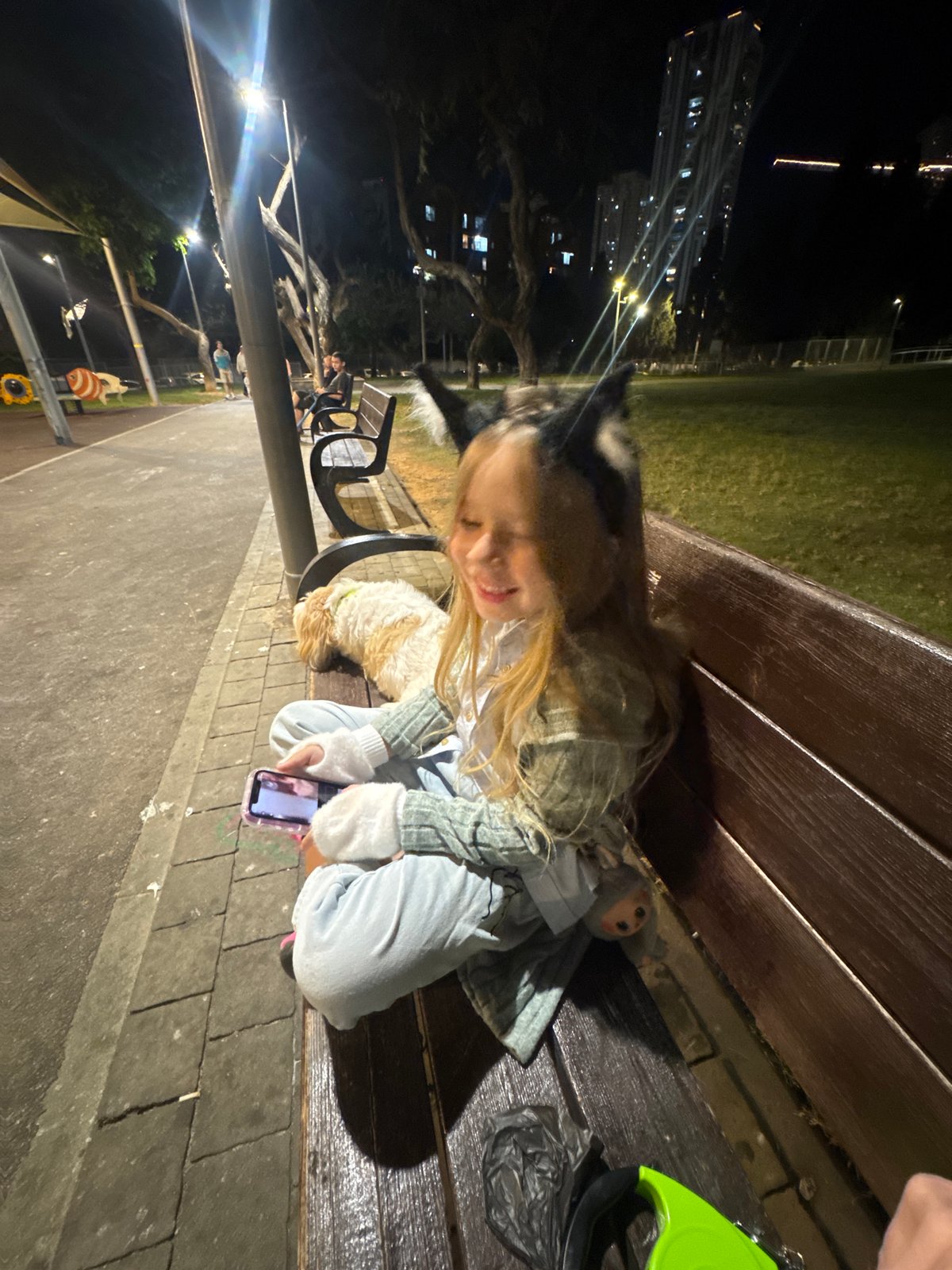 Girl spends afternoon with dog in Bat Yam park