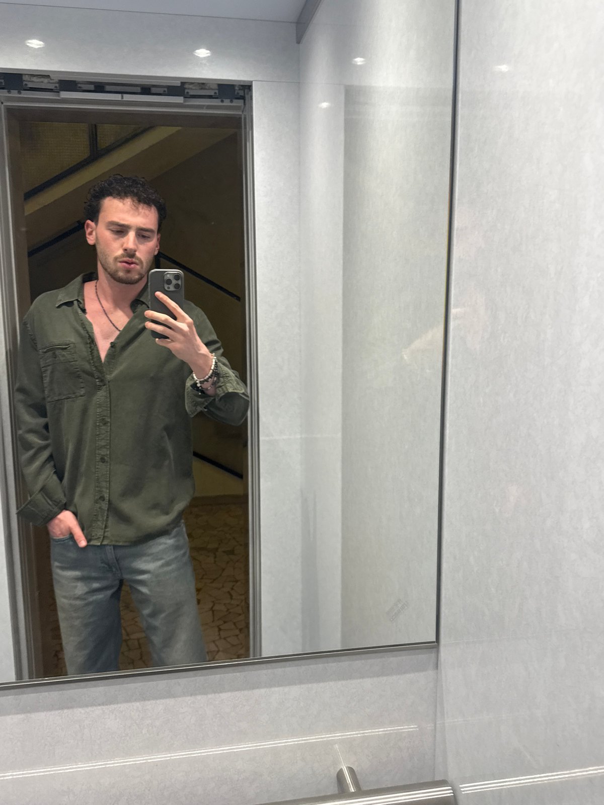Man Takes Selfie in Mirrored Elevator in Milan