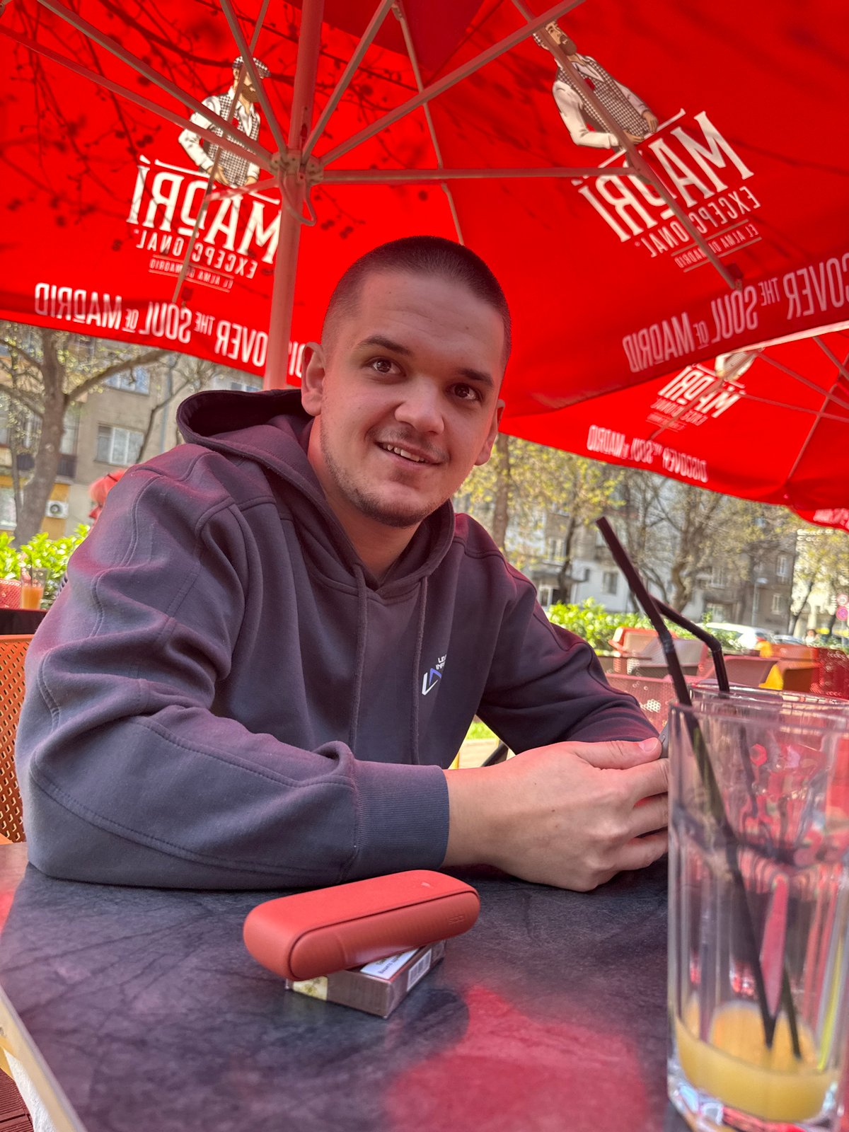 Man uses phone at outdoor cafe in Plovdiv