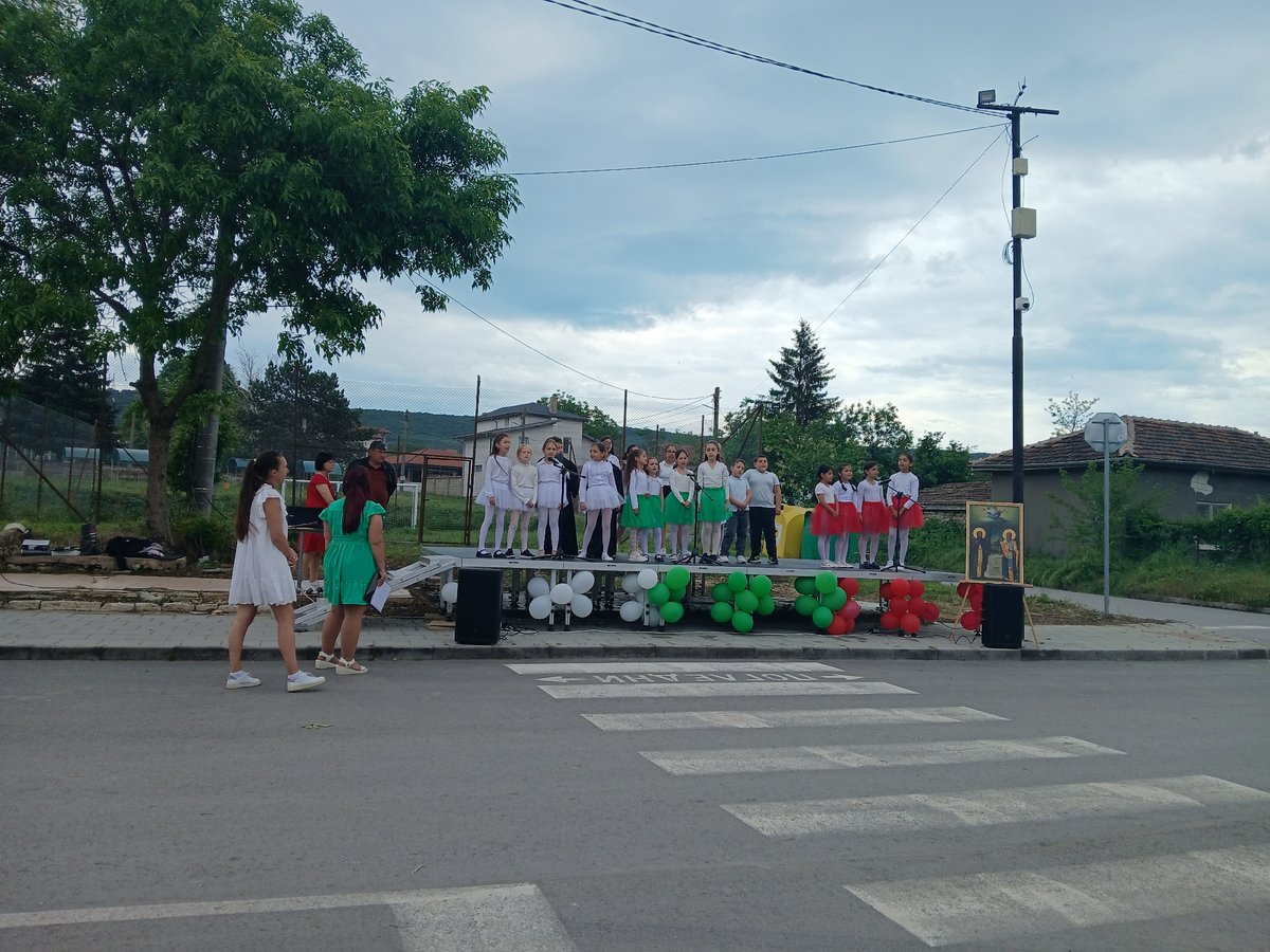 Children perform patriotic show on street crossing in Bulgarian village