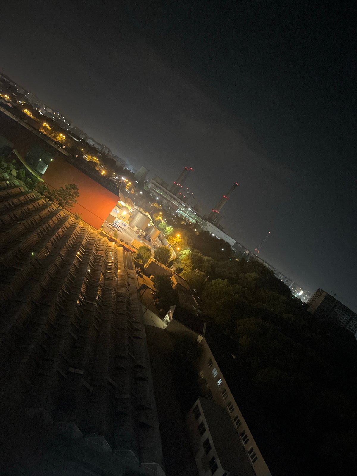 Nighttime aerial views over Bucharest's urban mix