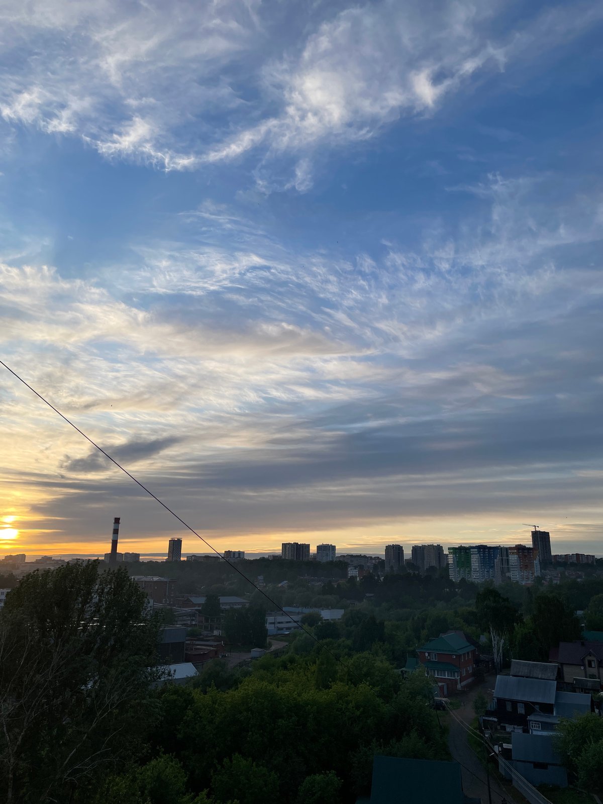 Sunset captured over Izhevsk cityscape with dramatic cloud formations