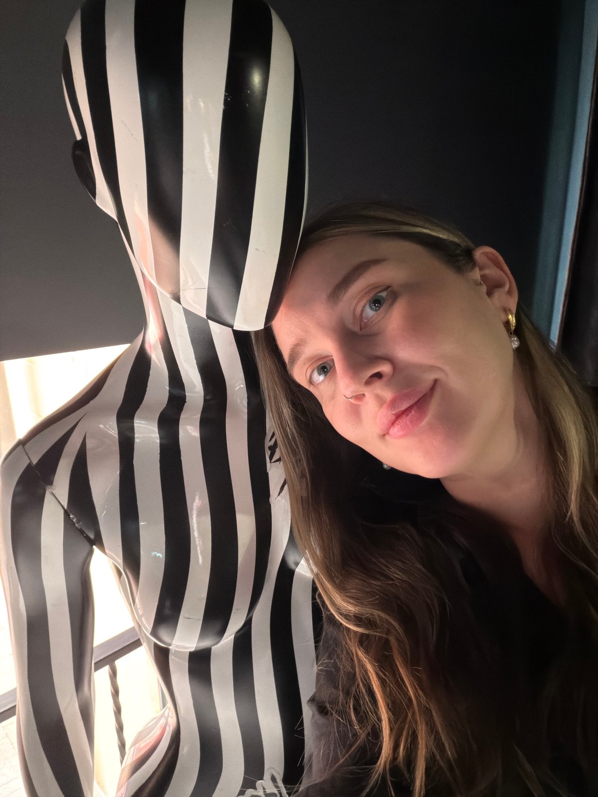 Woman photographed with art sculpture in Moscow indoor venue