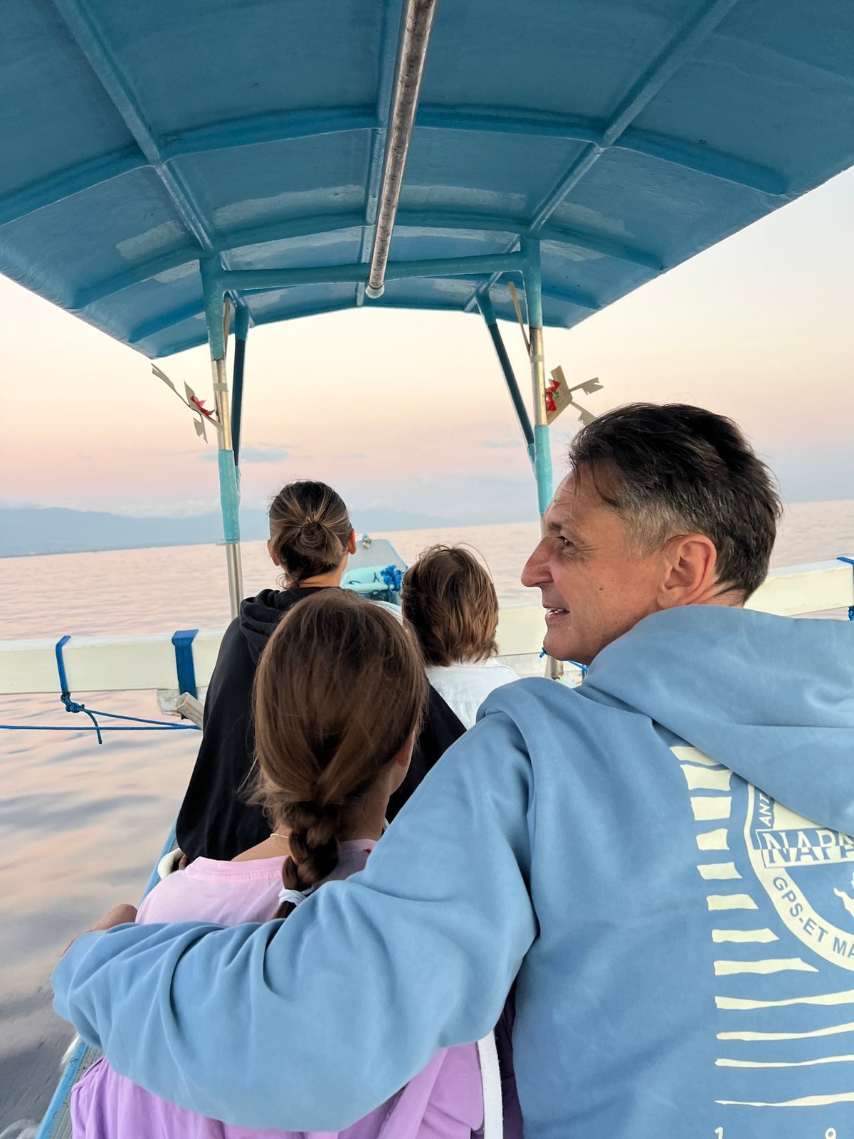 Quiet lake moment on a canopied boat at golden hour, Banjar