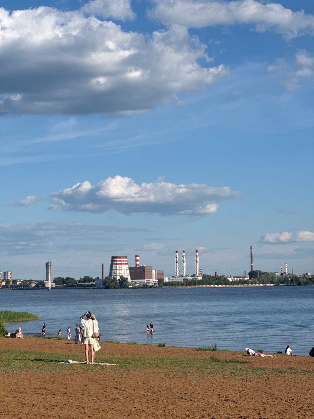Visitor documents sunny afternoon at Izhevsk waterfront park