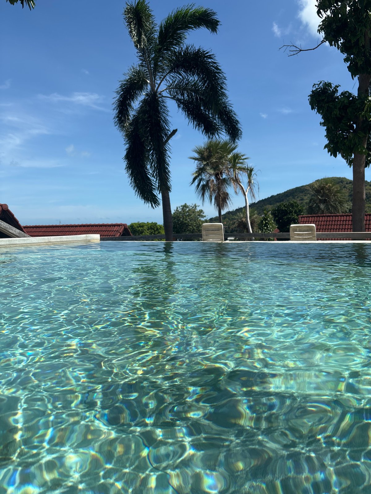 Mother and child enjoy early morning pool time in Thailand