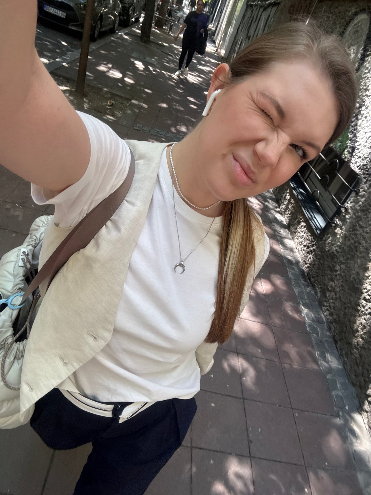 Woman enjoys morning coffee, takes selfies on Belgrade street