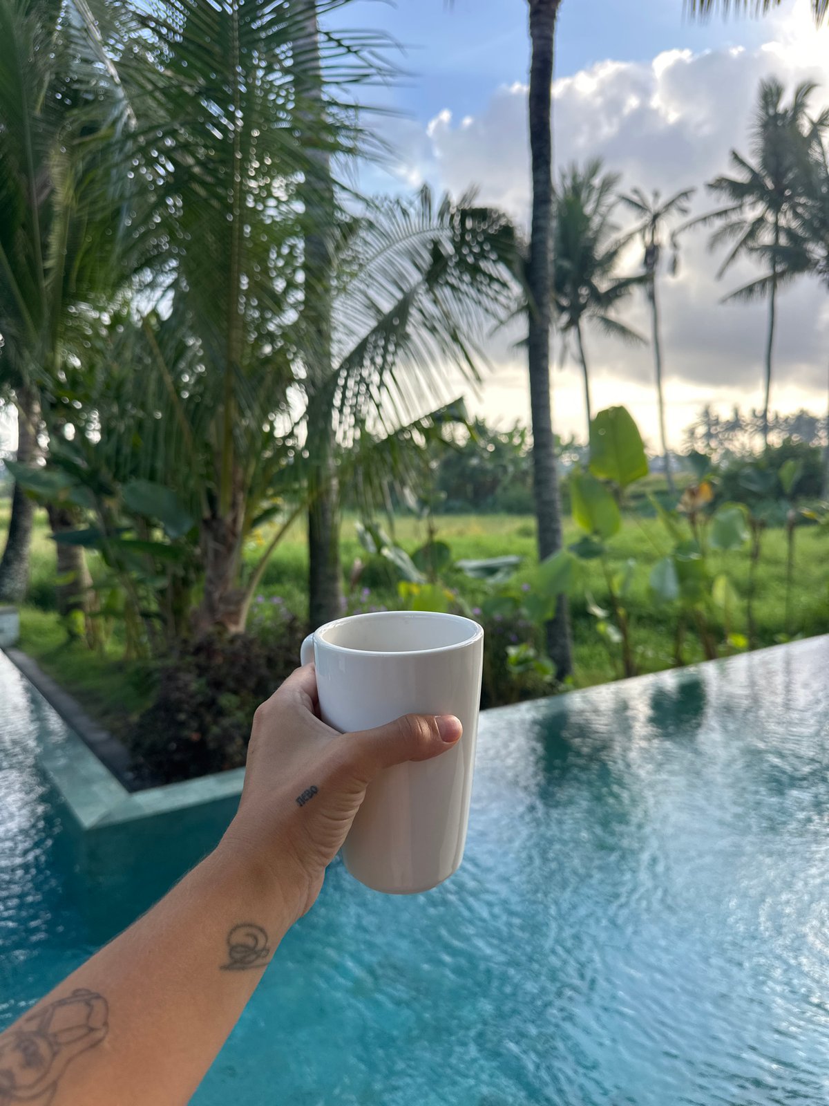 Morning coffee by tropical pool in Sukawati, Indonesia