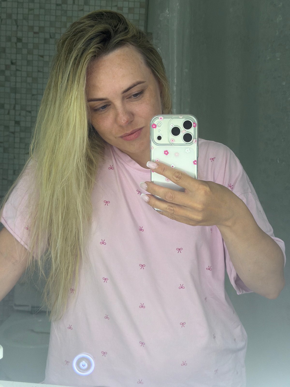 Woman takes mirror selfie in Votkinsk bathroom