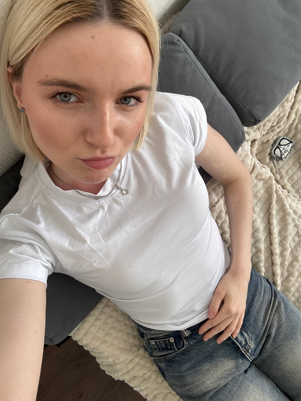 Woman relaxes with cat on bed in Vsevolozhsk