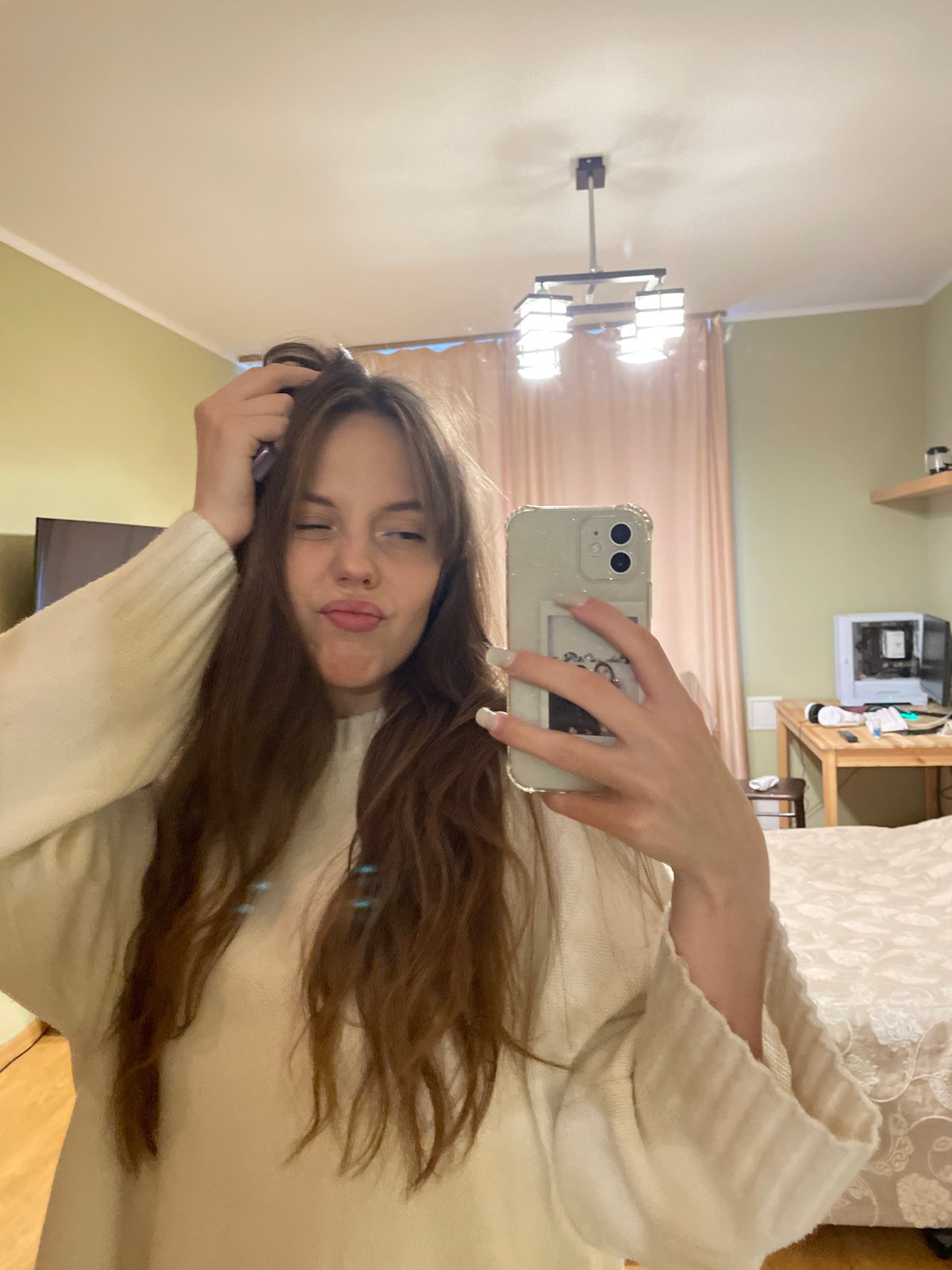 Woman takes selfies while styling hair in Ufa residence