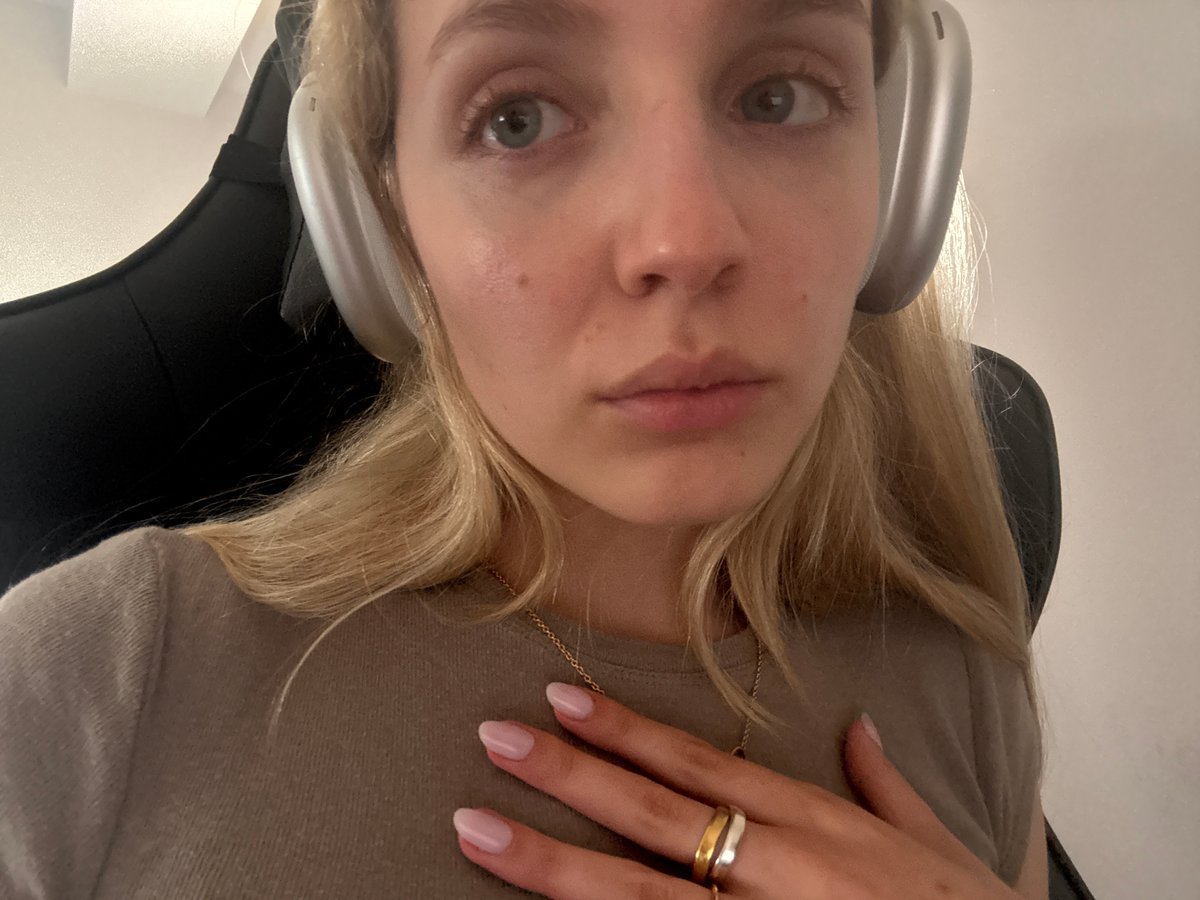 Woman with headphones, dog observed indoors in Mexico City