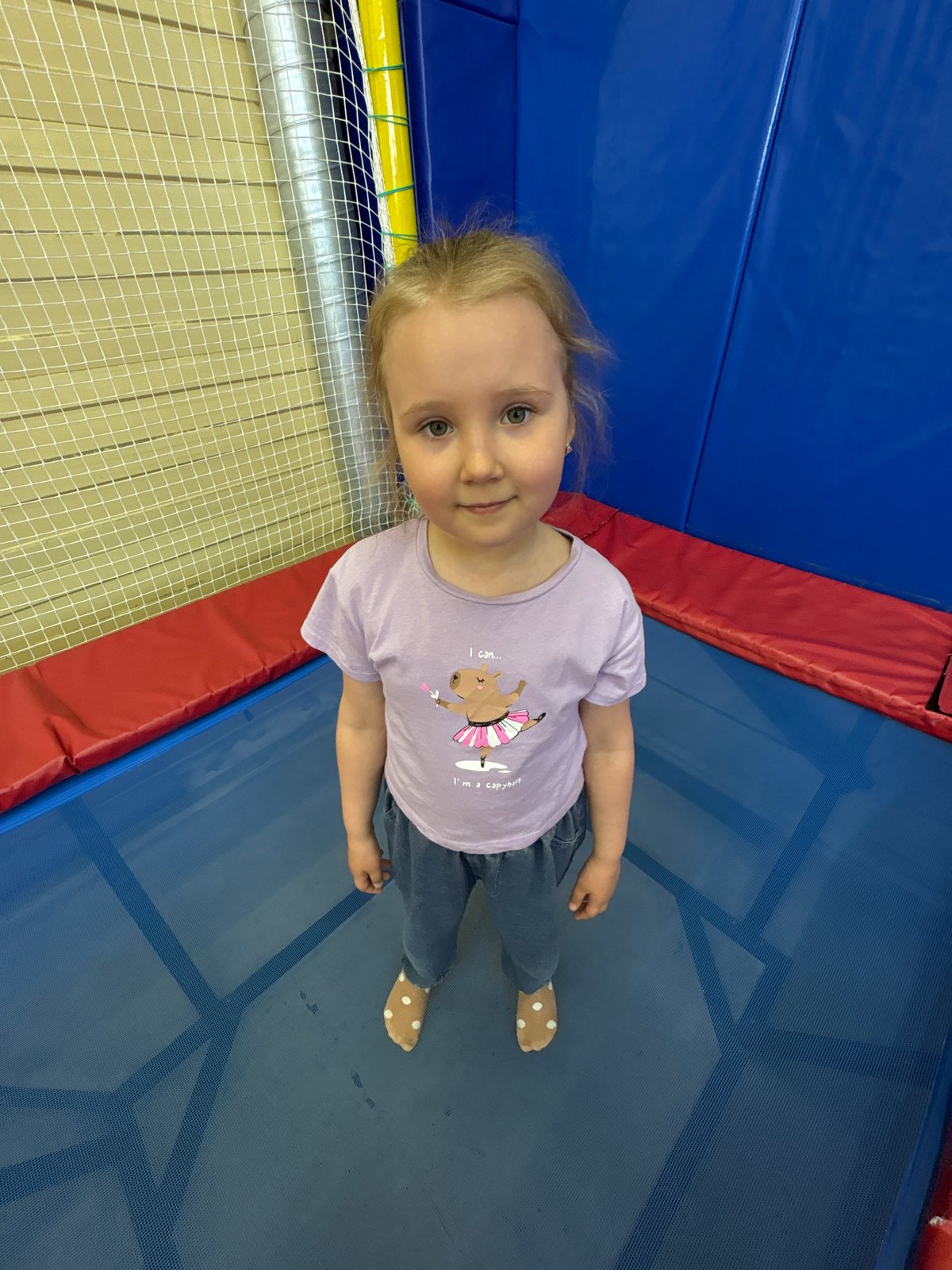 Young girl enjoys trampoline play at indoor recreation facility