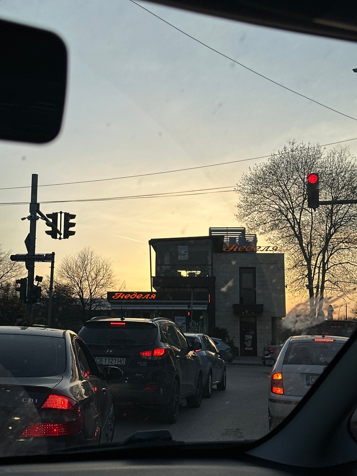 Evening traffic flows through central Sofia near Nedelya shop